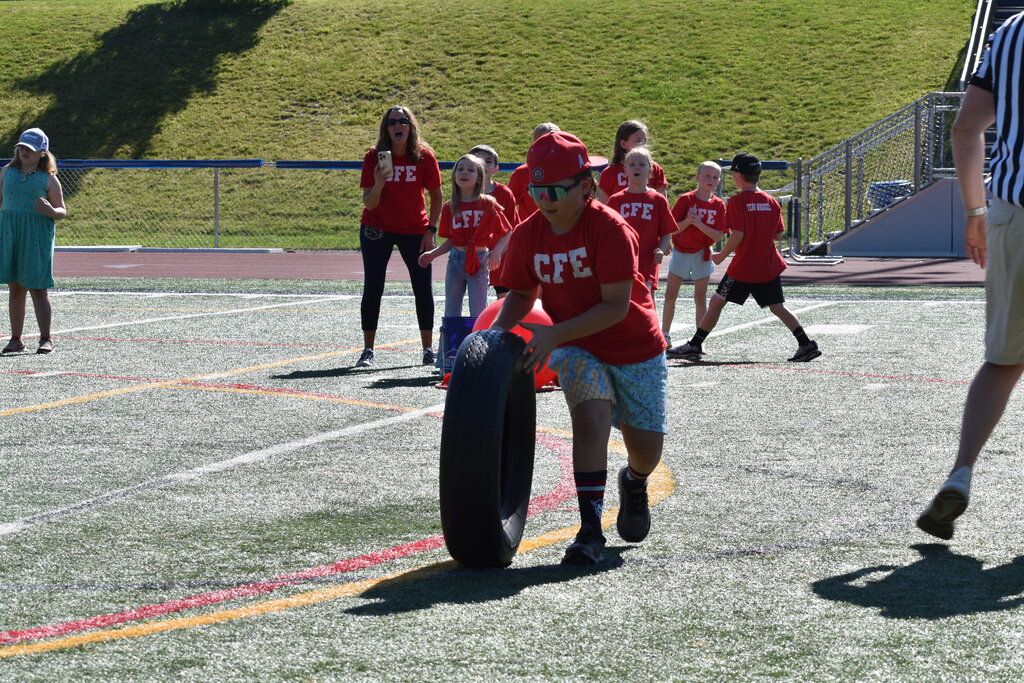 elementary student rolling tire