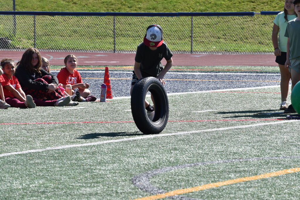 elementary student rolling tire