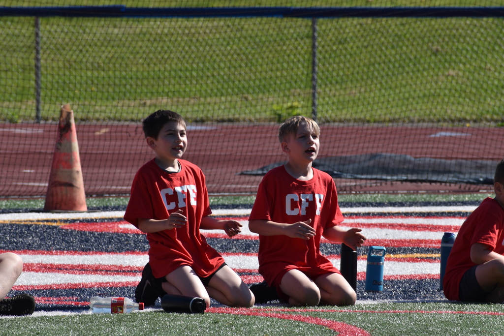elementary students on football field 