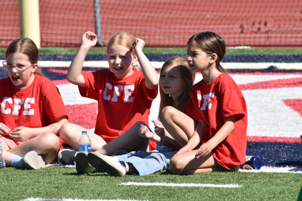 elementary students on football field 