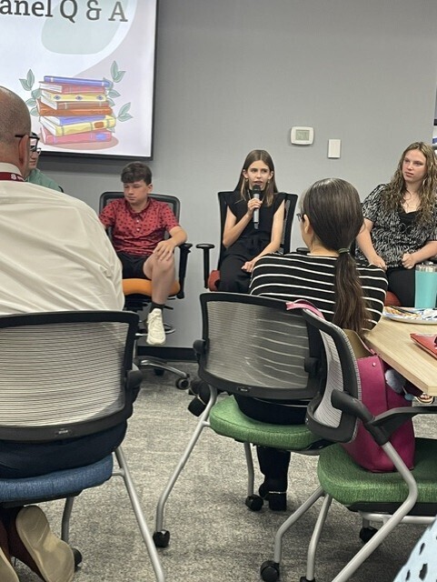 student speaking in microphone