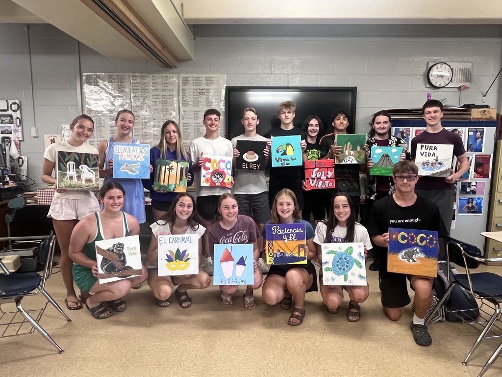 high school students with painted ceiling tiles