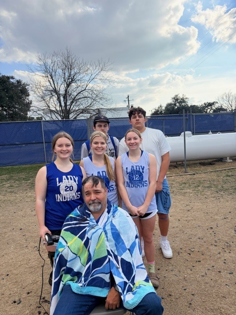 5 engineering students standing around Mr. Bordner (shaved head)