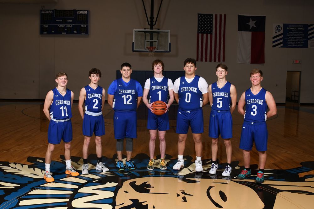 Varsity BoysBasketball team in uniform in the gym