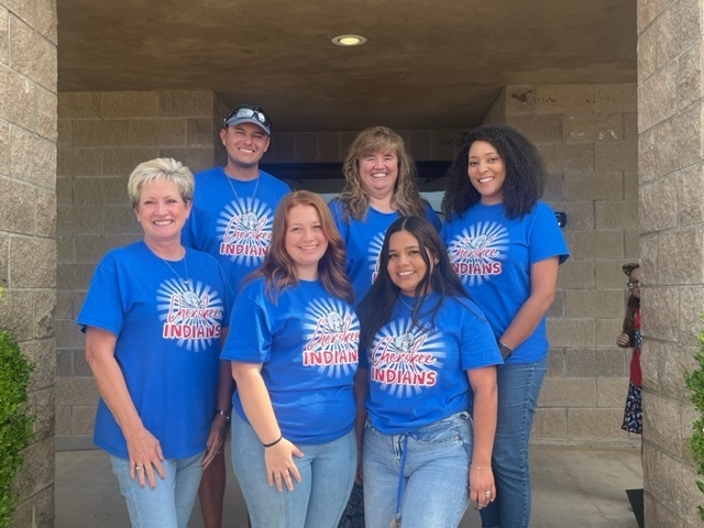 Six new staff members wearing blue staff tshirts