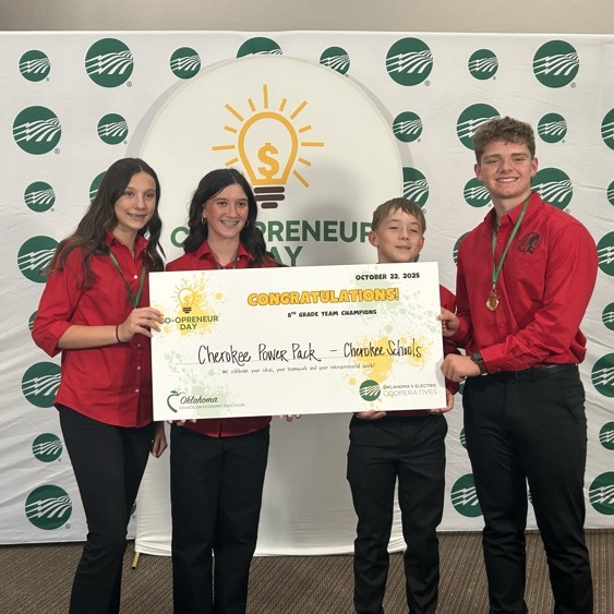 4 students hold a sign that reads Cherokee Power Pack - Champions 8th grade division