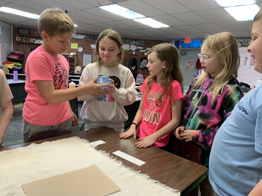 Students in 1st grade completing a science experiment. 