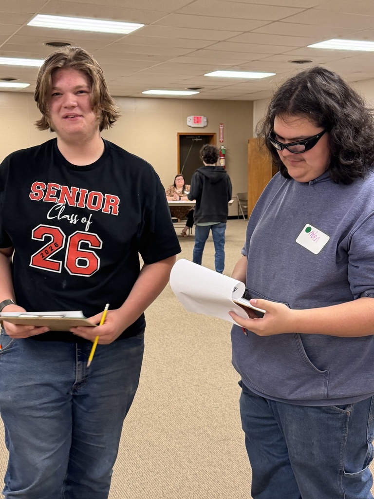 Students attending an event, learning about financial literacy. 