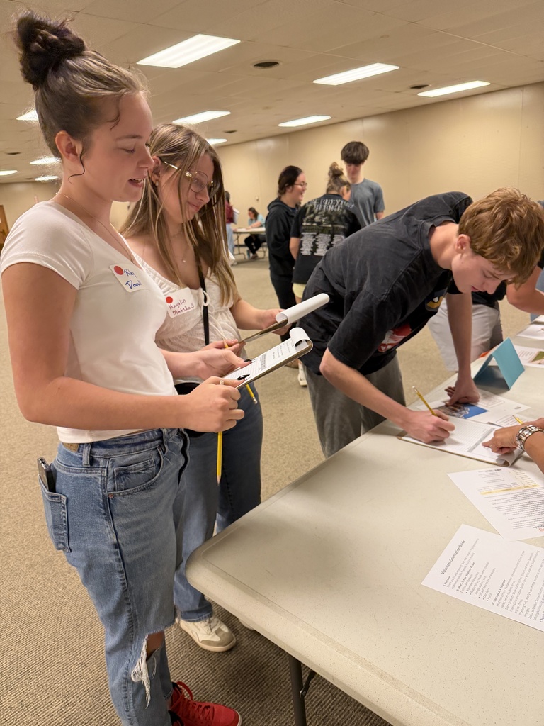 Students attending an event, learning about financial literacy. 