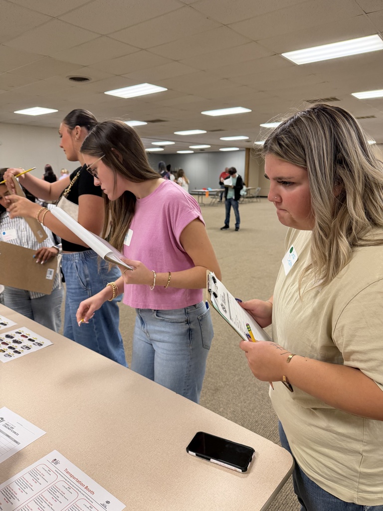 Students attending an event, learning about financial literacy. 