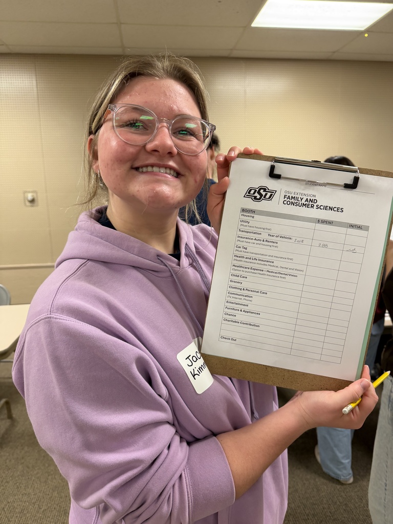 Students attending an event, learning about financial literacy. 