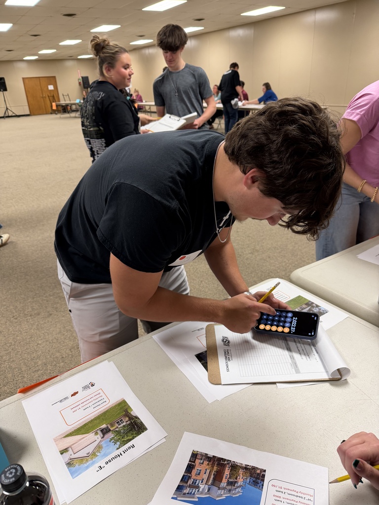 Students attending an event, learning about financial literacy. 