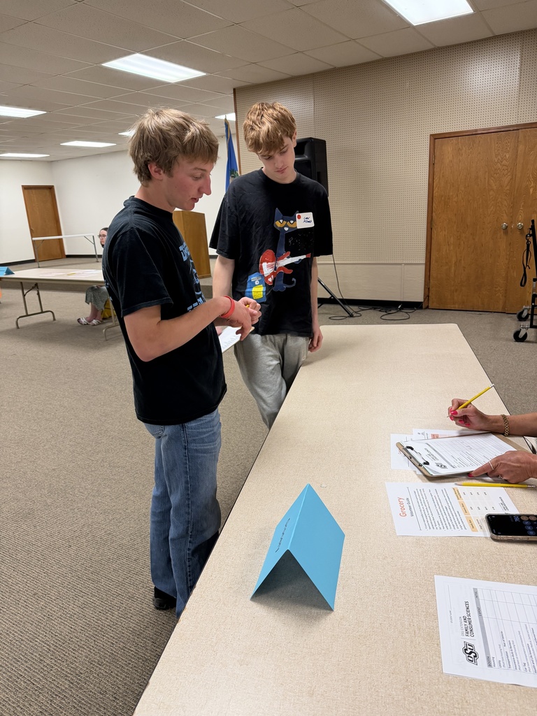 Students attending an event, learning about financial literacy. 