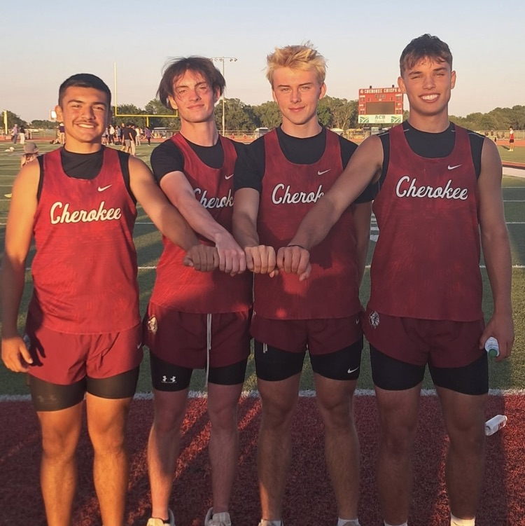photo of 4 students in track uniform