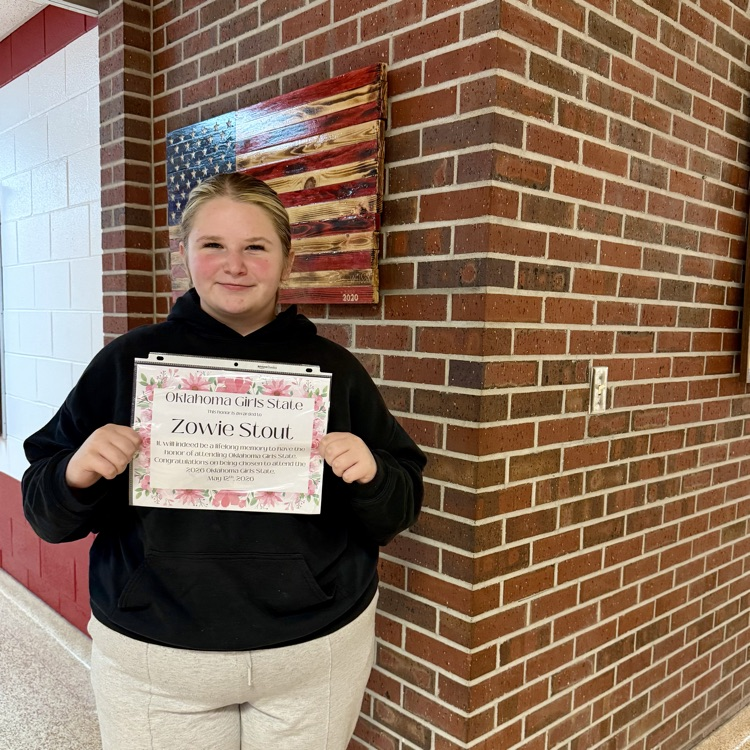 photo of a female student holding a certificate about attending Girls State Camp