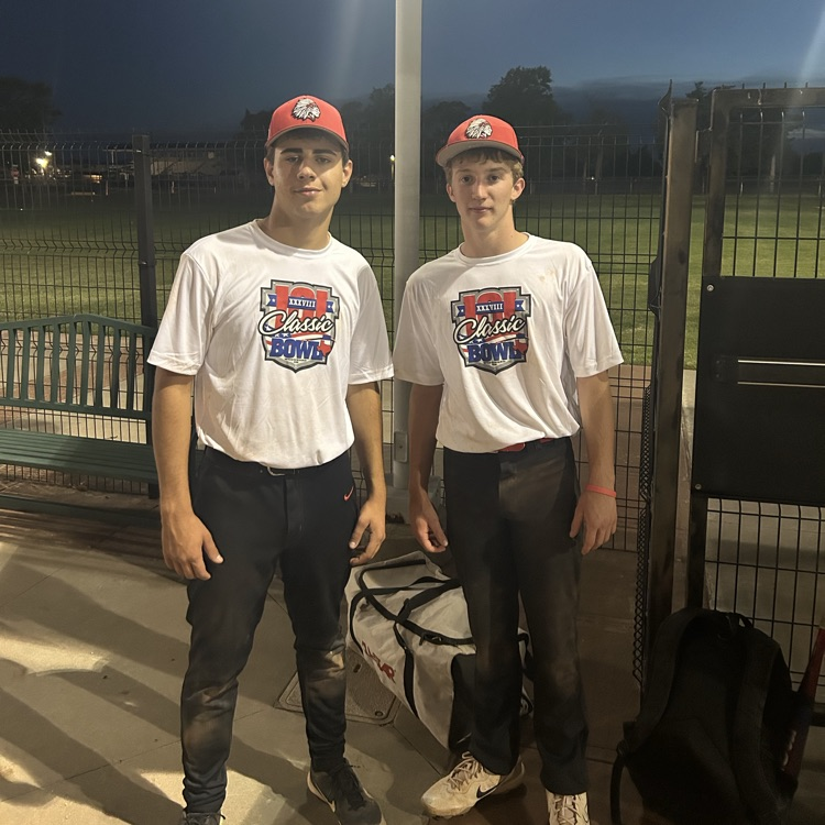 2 students at the K101 classic baseball game  