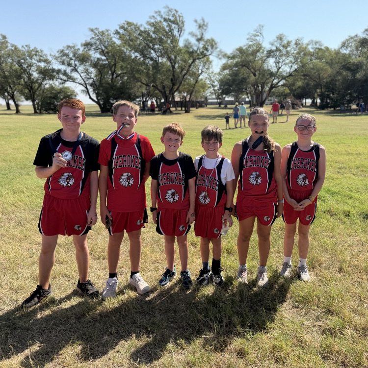 6 students in red uniforms at cross country meet