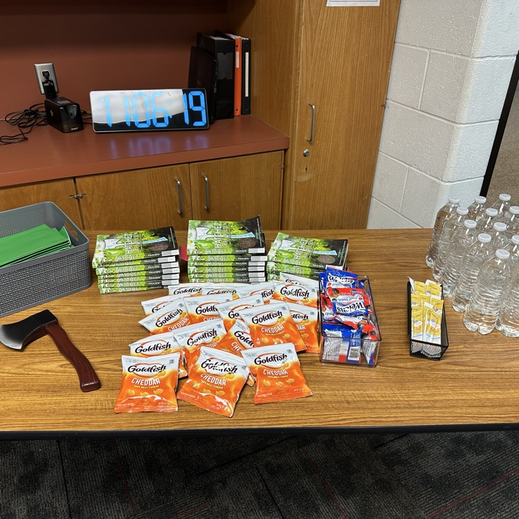 picture of a table in a classroom with goldfish crackers and water