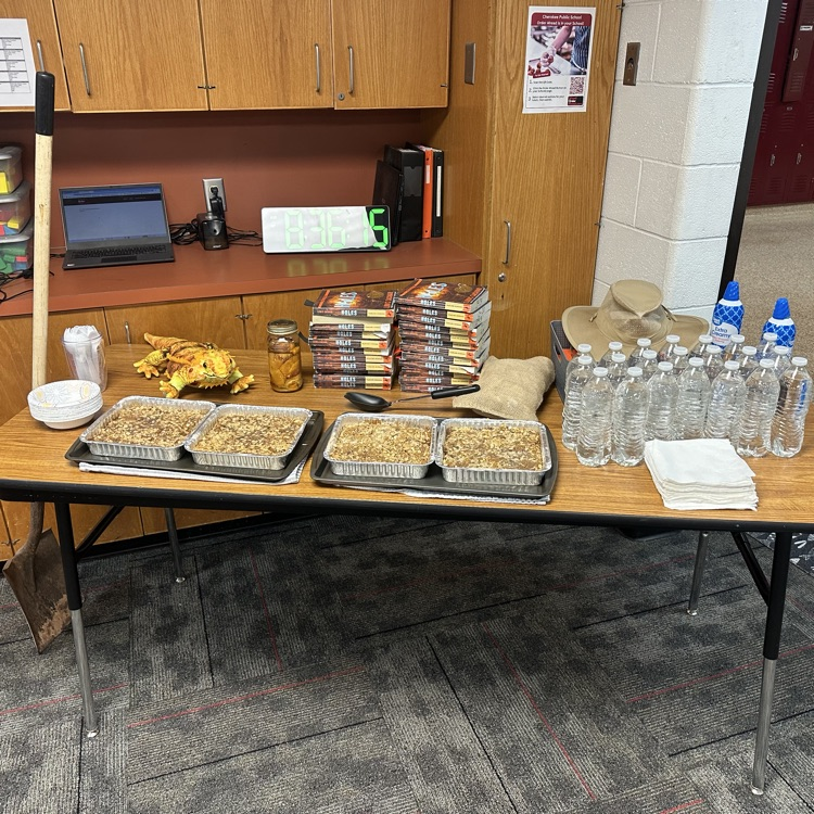 picture of a table in a classroom with water & peach crisp