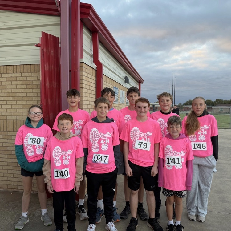 cherokee cross country team standing together wearing pink t-shirts