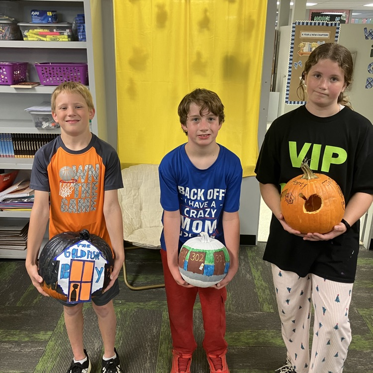 Group of students in a classroom with decorated pumpkins