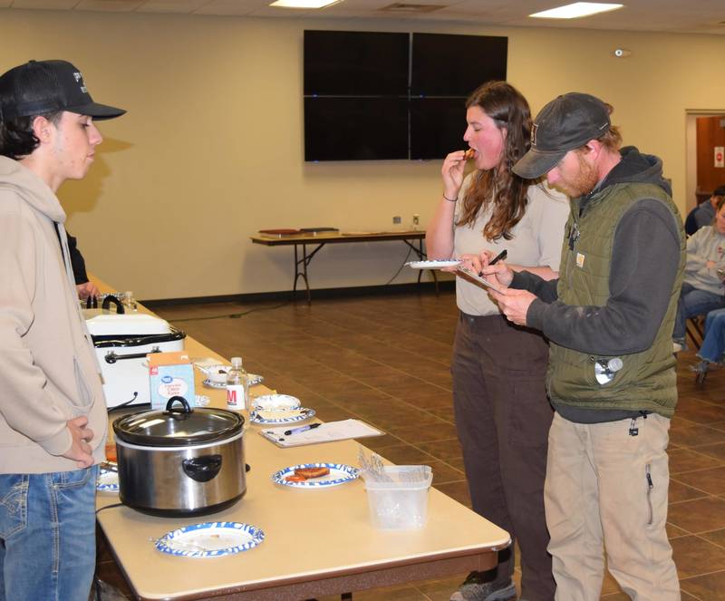 Judges Chris Porter and Melissa Robbell try Carp Patties made by Cash Cantellay.