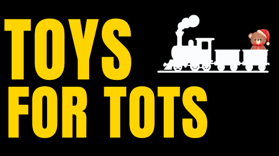 Banner graphic for the Toys for Tots holiday collection drive, featuring large yellow text reading 'Toys for Tots', a white silhouette of a train, and a small bear wearing a Santa hat.