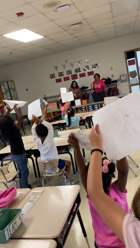 students showing off their cookie drawings