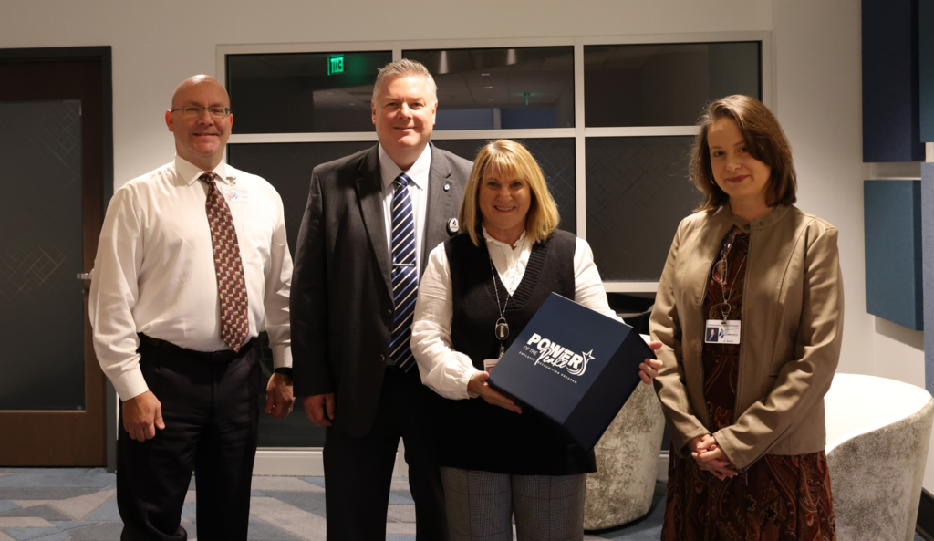 Superintendent, HR Director, and Peake winner smiling