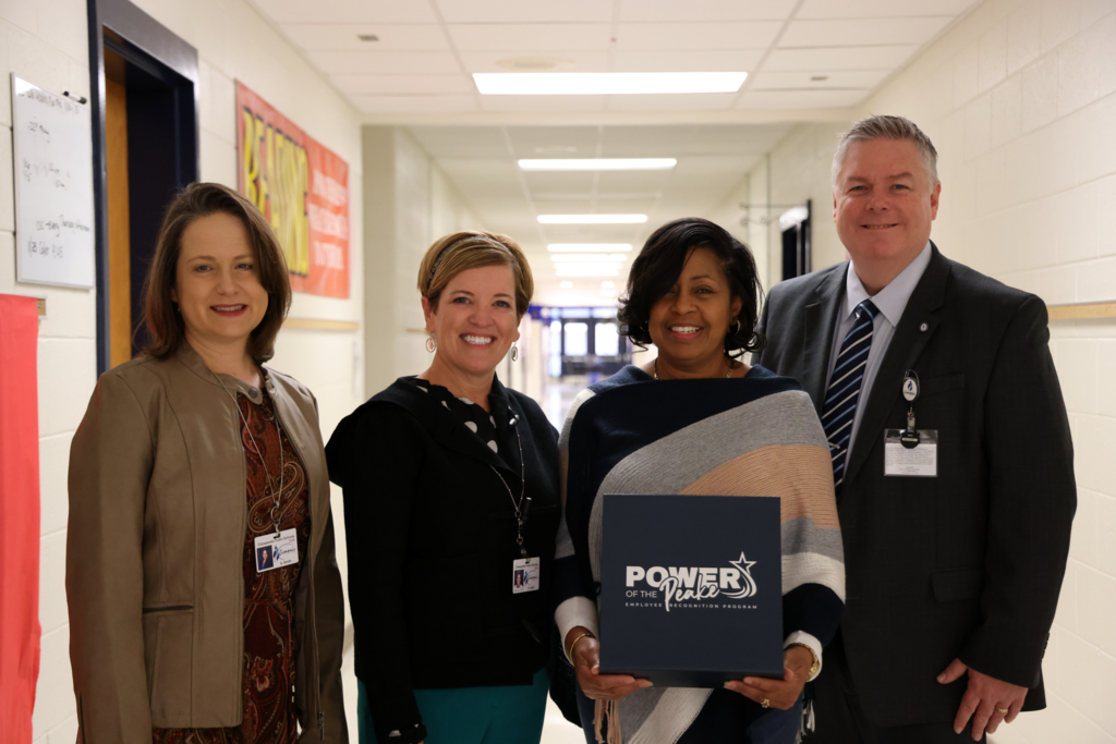 Principal smiling with leadership