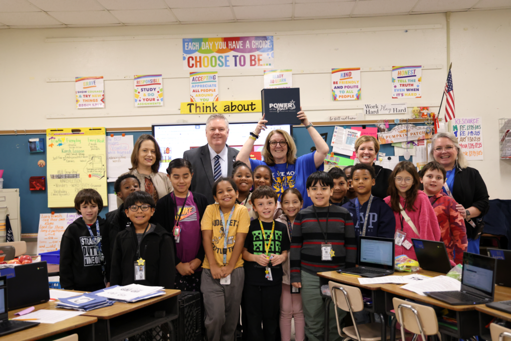Teacher with students and admin smiling
