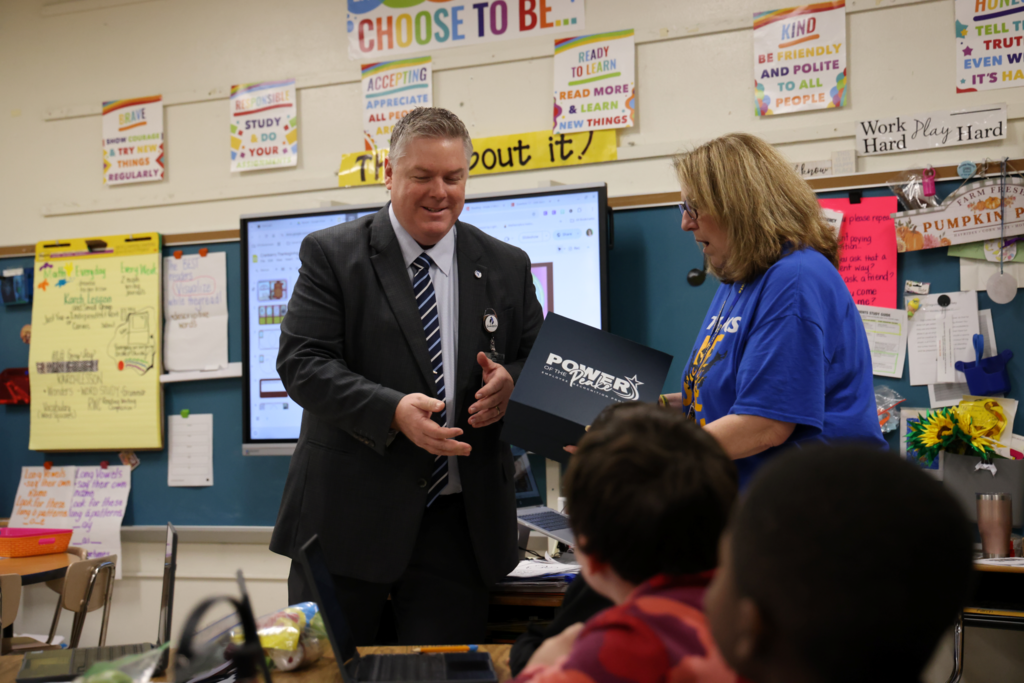 Dr Cotton awarding teacher