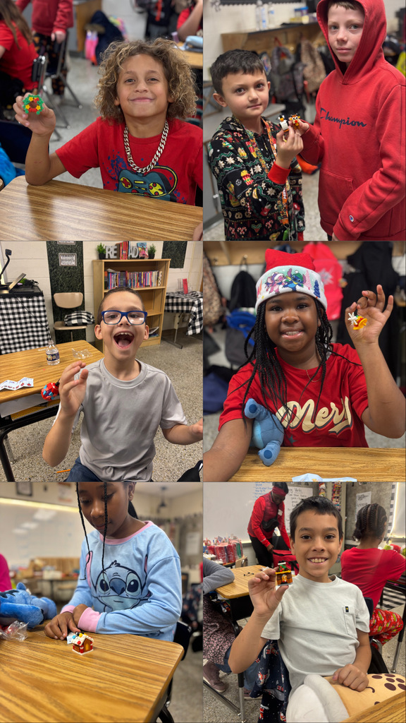 Students holding up ornaments