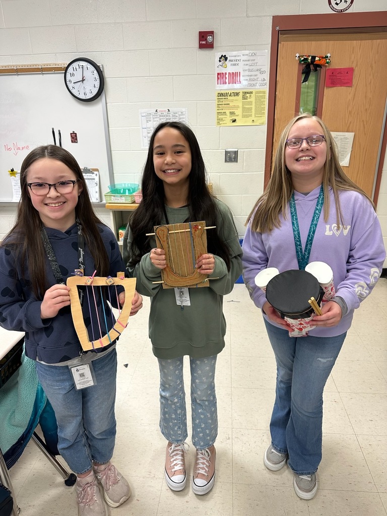 Some of Mrs. Claytor's talented students proudly showcasing the instruments they created for their sound project.