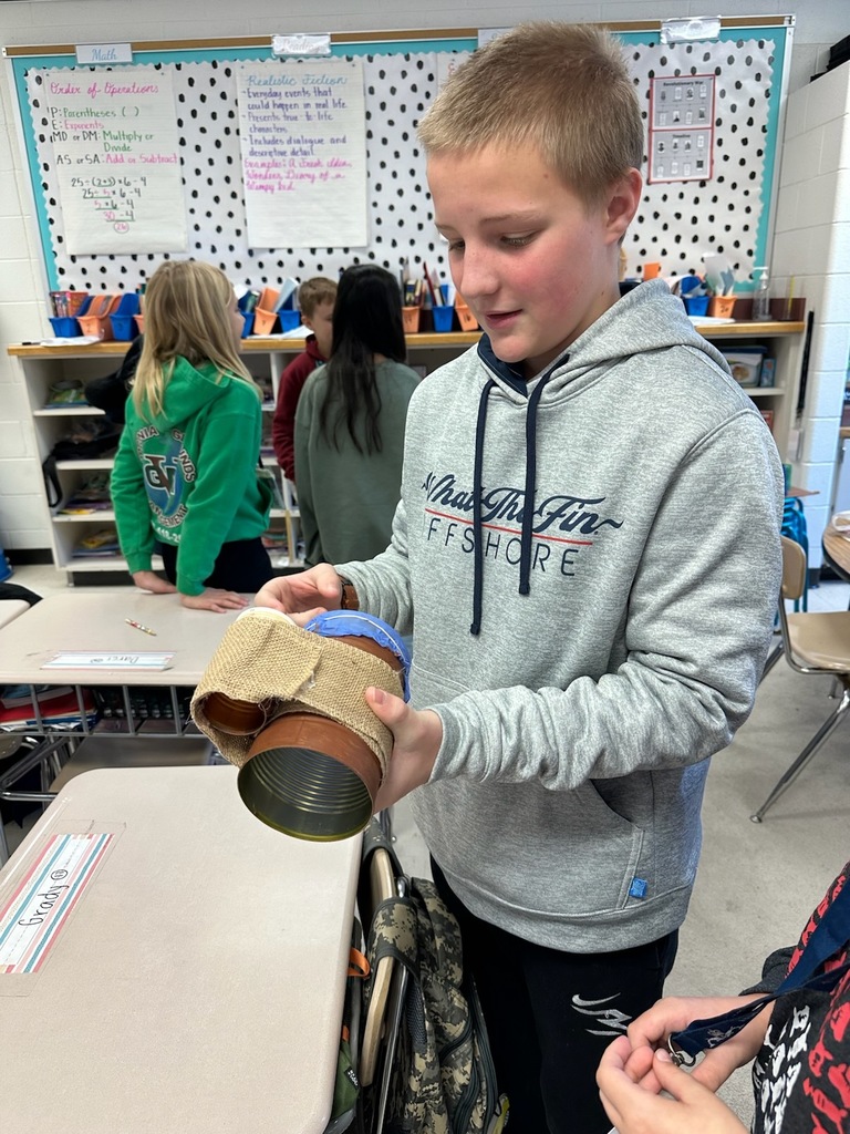 Some of Mrs. Claytor's talented students proudly showcasing the instruments they created for their sound project.