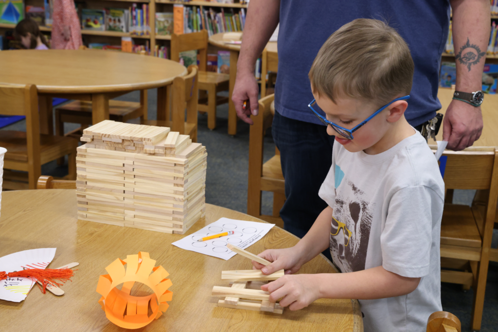 boy playing with jenga blocks