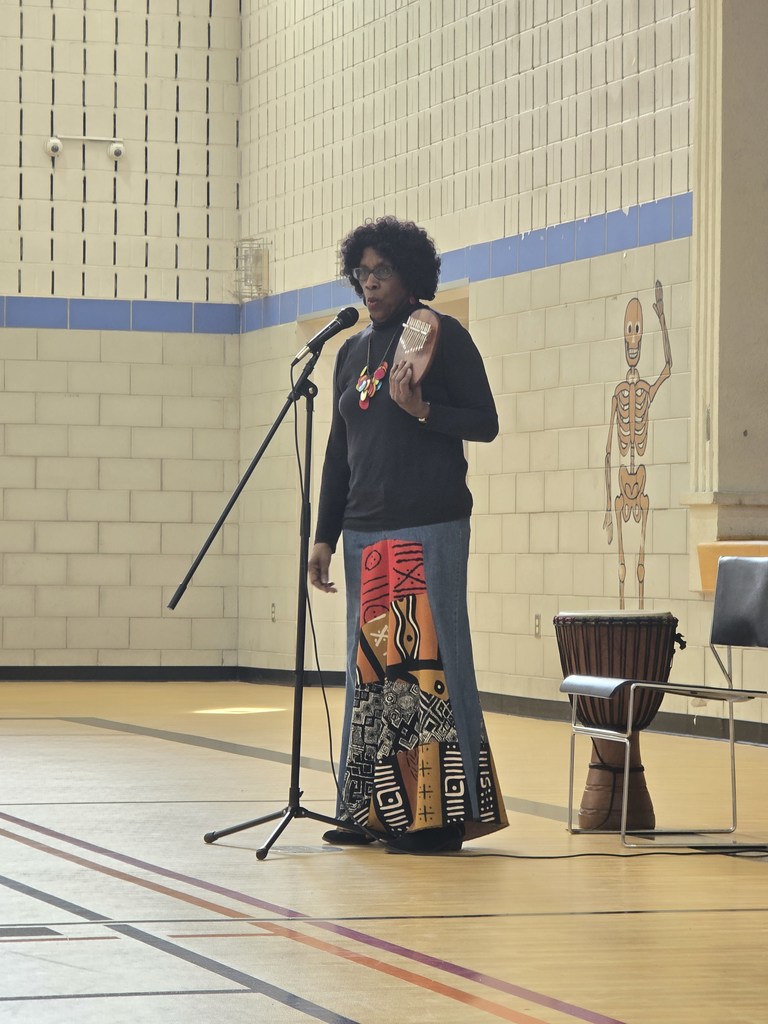 African storyteller holding a small instrument