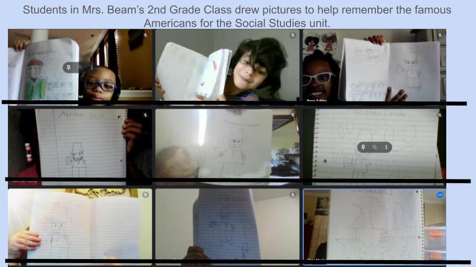Students holding paper with their drawings