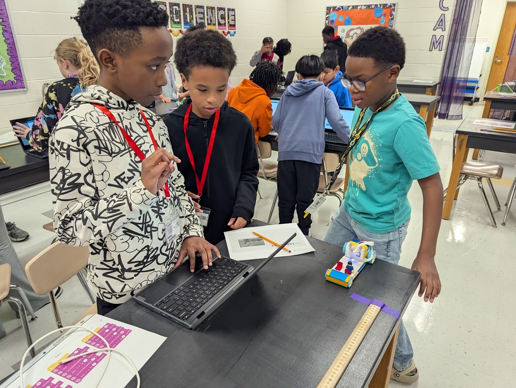 students using a chromebook and Lego car