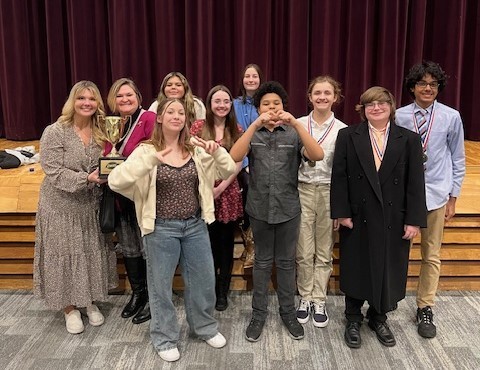 Speech team smiling and with trophy