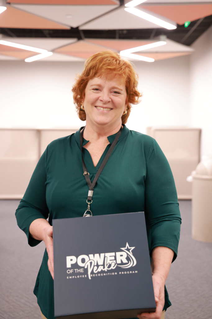 woman admin smiling with Power of Peake box