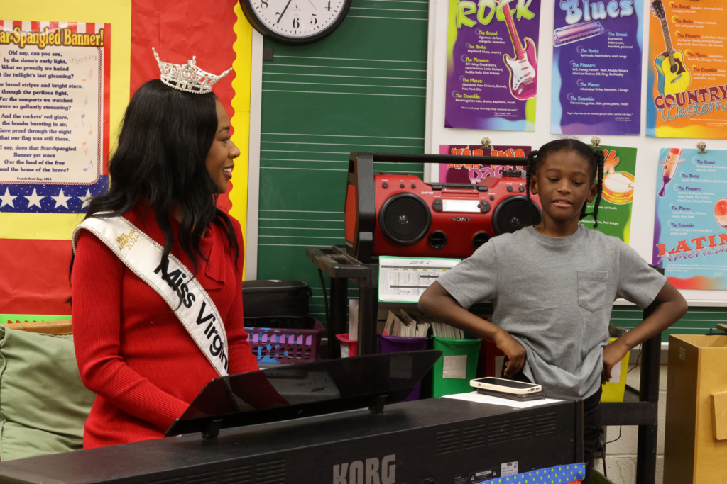 Miss Va with male student at piano