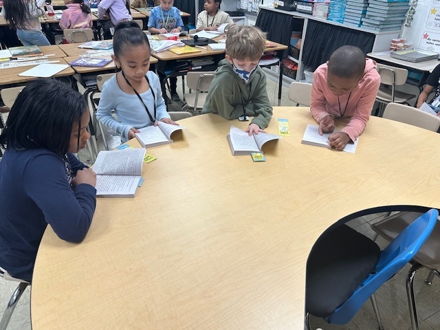students reading at a table