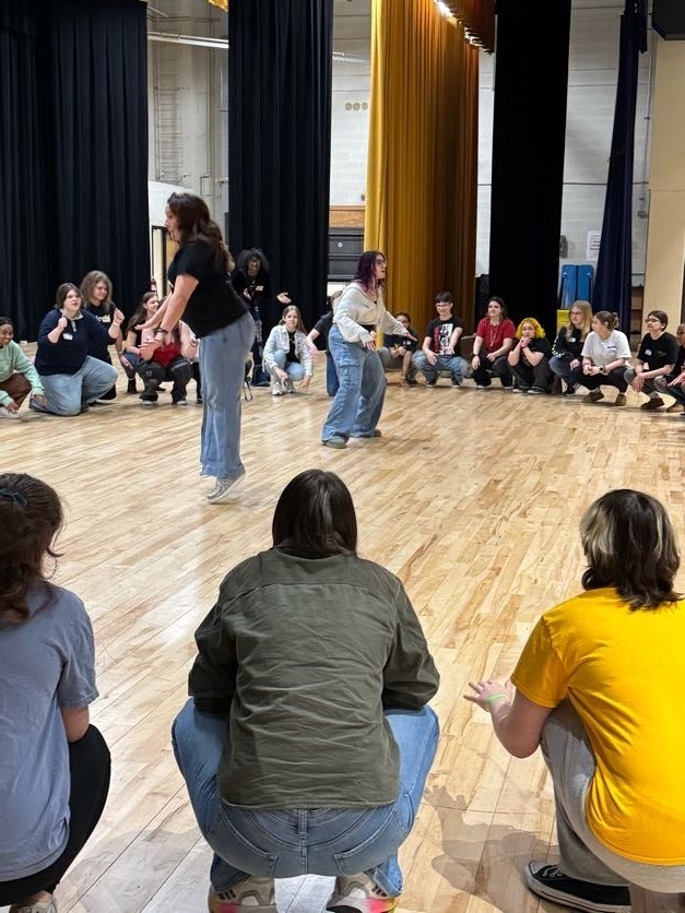 teacher and students acting in circle