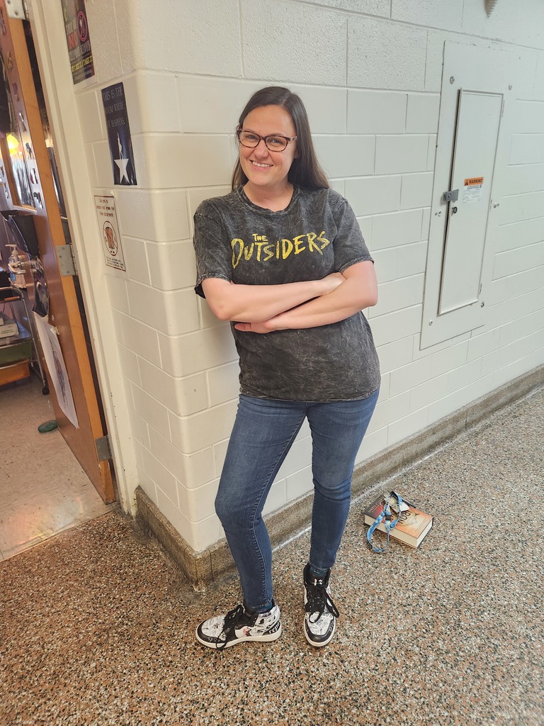Teacher wearing outsider shirt