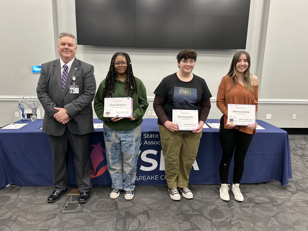students smiling with Dr. Cotton and their award certificates