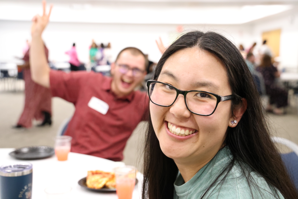 boy photobombing and smiling