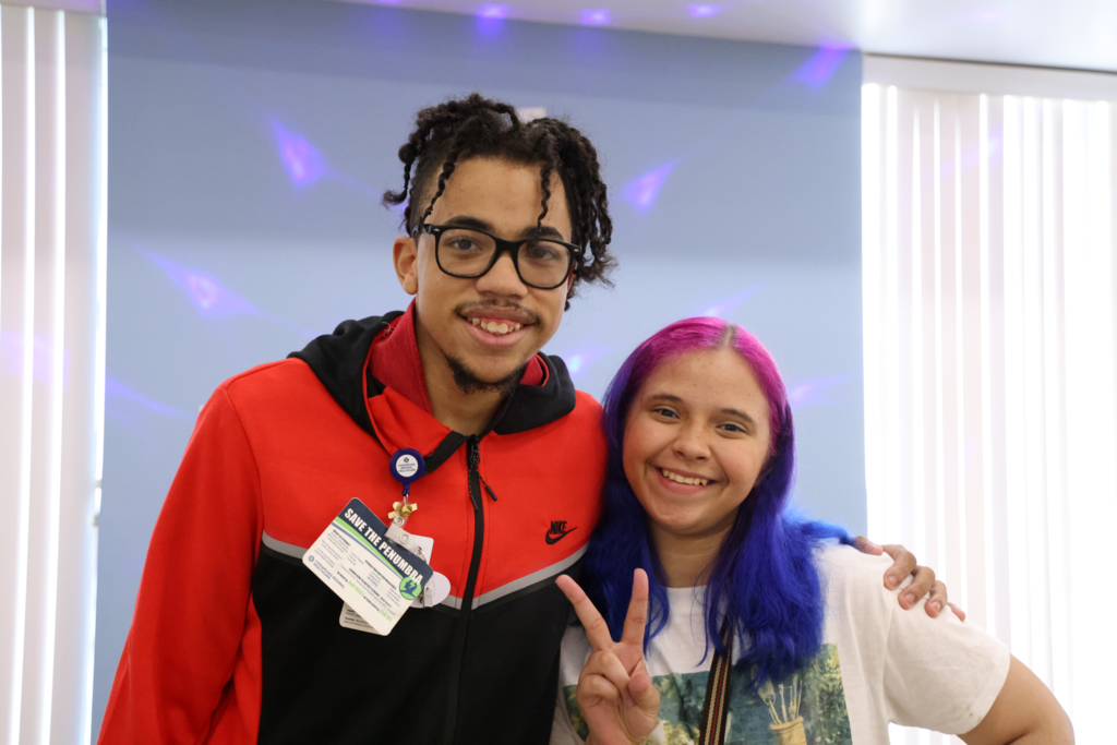 girl and boy posing for camera