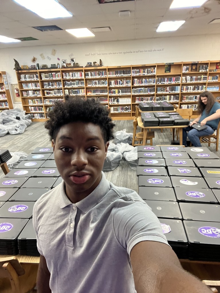 Carlos working with a lot of chromebooks.