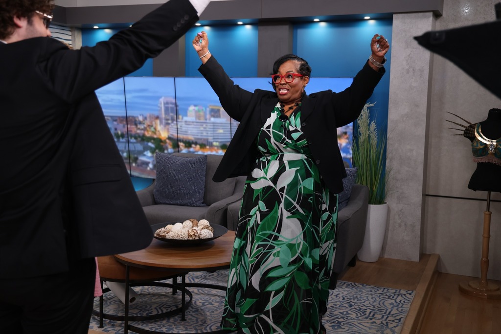 Lisa and the host celebrating.